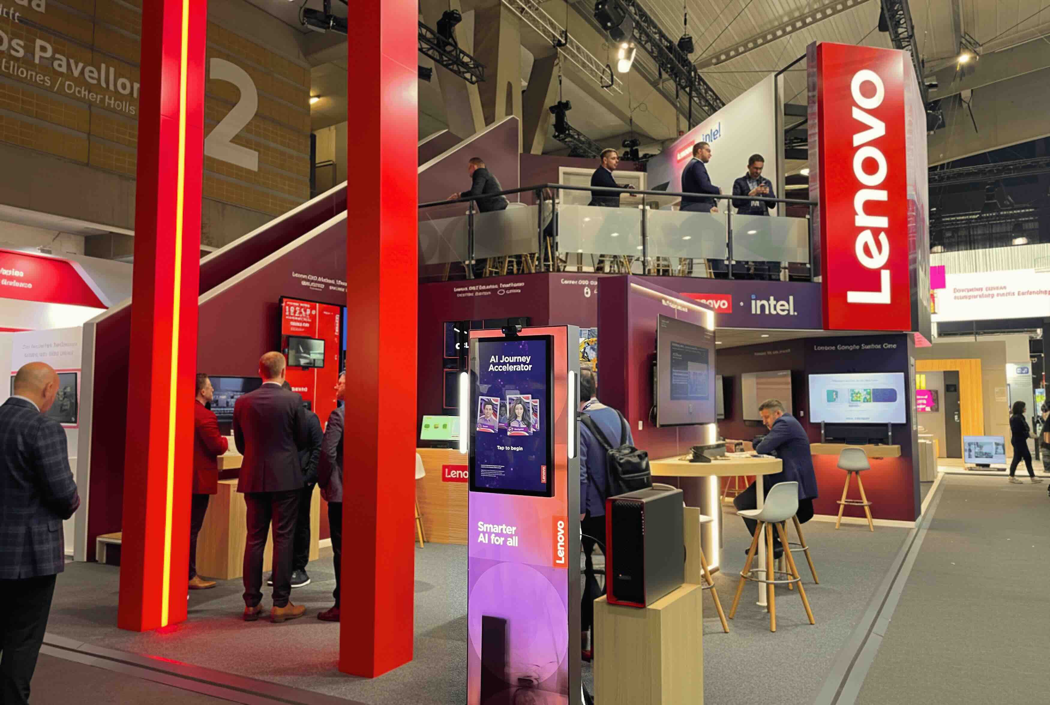 Entrance to Lenovo stand at ISE 2026 with red illuminated arch, screens and open two-story design