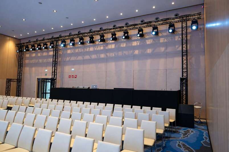 FOH control position and truss with lighting in one of the rooms