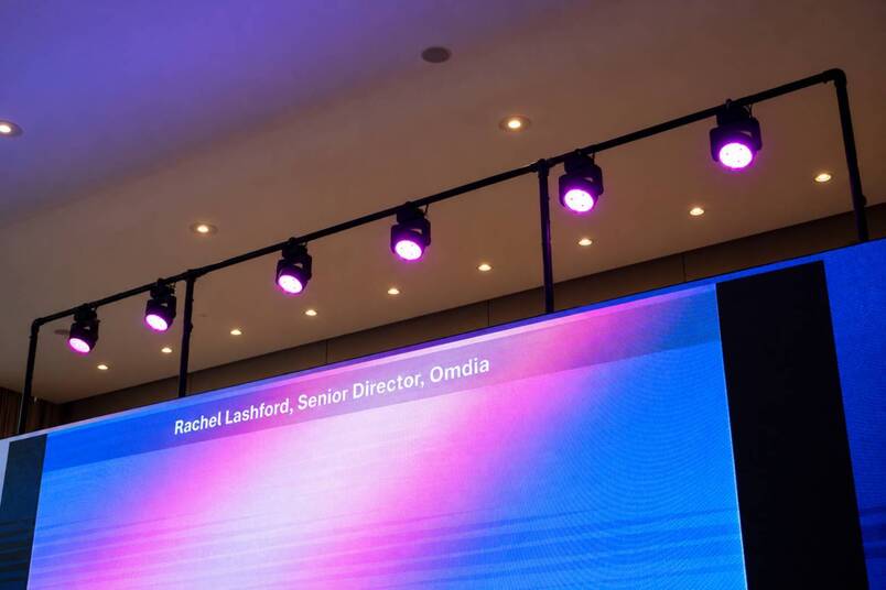 Backlight fixtures on a pipe structure above the LED screen