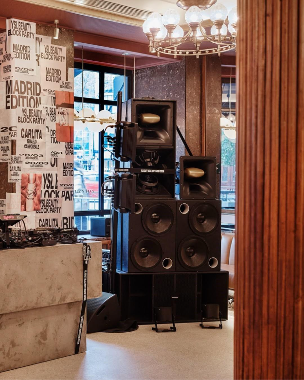ound tower set up for YSL Beauty Block Party next to DJ booth and event graphics at Café Comercial Madrid