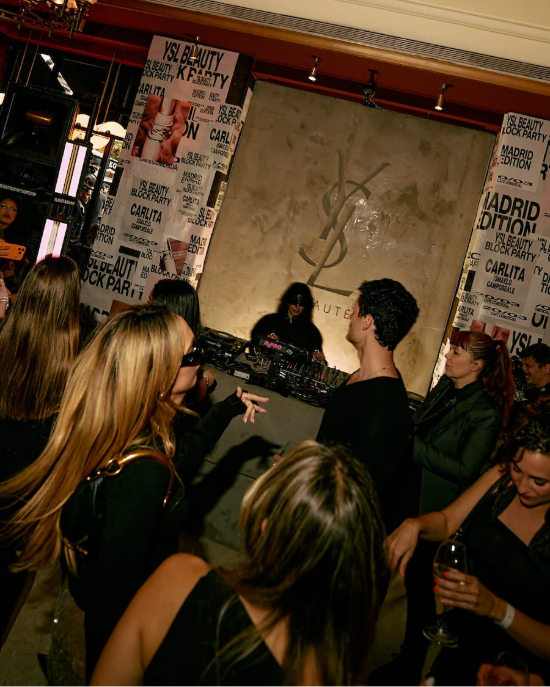 DJ area at Café Comercial with illuminated YSL panel and audience enjoying the YSL Beauty Block Party Madrid.